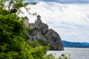 Fortress crowns cliff over misty Danube, whispering echoes of medieval Slavic legends, framing...