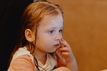 An expressive 3-year-old girl watches cartoons on a tablet, capturing genuine childhood reactions...