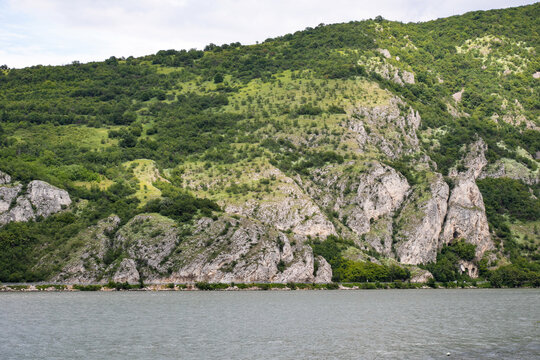 Lush, emerald-clad cliffs embrace their stony kin, echoing hidden fables of Earth Day reverie and Sacred Cliffs Festival