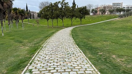 Cobbled path meanders through lush greenery, echoing tranquility and wanderlust, ideal for World...