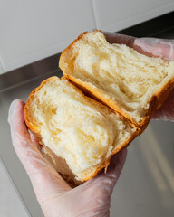 Fluffy brioche split open, golden layers whisper buttery secrets, ideal for Bastille Day feasts and...