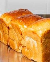 Golden brioche loaf gleaming on reflective surface, perfect for Bastille Day breakfast or...