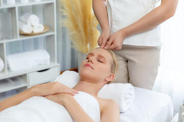 Caucasian woman enjoying relaxing anti-stress head massage and pampering facial beauty skin...
