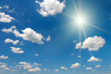 Bright midday sun and beautiful blue sky with clouds.