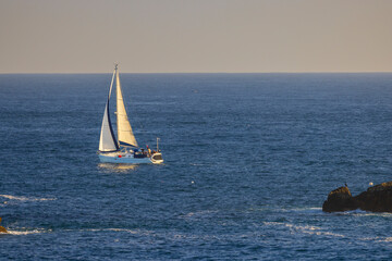 Fototapeta premium Sailboat sailing near the coast of Saint Pabu in Brittany, France