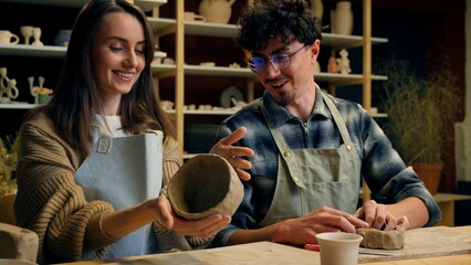 Caucasian family smiling girl guy couple date in pottery workshop handmade master class woman...