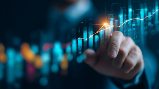 A person pointing at a digital stock chart with rising trend line and blue bar graph elements shown