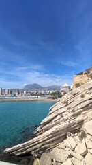 Coastal cityscape of Benidorm, Spain, featuring sandy beaches, clear blue water, and modern skyline. Popular Mediterranean destination known for tourism, sun, and vibrant seaside views.