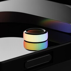 Unique smart ring is depicted with rainbow colors on a reflective black surface