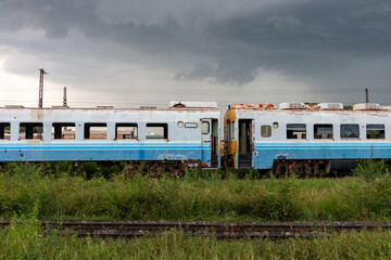  vintage passenger train travels on city railway tracks