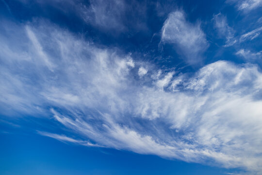 Wispy cirrus clouds painting the deep blue sky - Powered by Adobe
