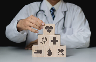 Businessman hand arranging wood block stacking with the healthcare medical icon. Health insurance  health concept