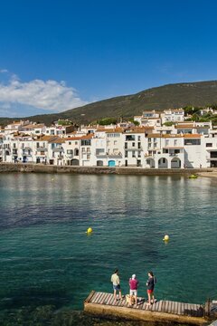 Charming Cadaqu&eacute;s, with small boats, white houses and vibrant blue sky, showcasing the historic Mediterranean coastal town&rsquo;s beauty and traditional architecture