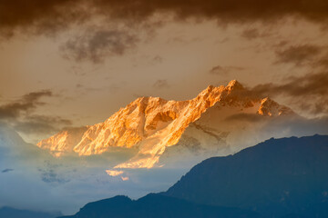 Beautiful last light from sunset on Mount Kanchenjugha, Himalayan mountain range, Sikkim, India. color tint on the mountains at dusk