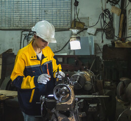 Industrial engineer technician worker woman with helmet and uniform safety vest look hand holding...