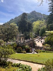 Gothic-Renaissance palace of Quinta da Regaleira in Sintra, Portugal, surrounded by lush gardens. A mystical UNESCO site known for architecture, history, and romantic charm.