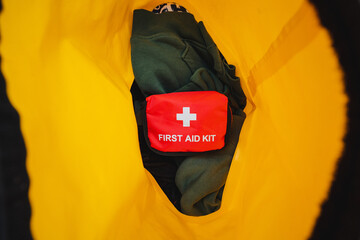 A red first aid kit with a white cross on it