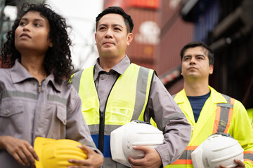 Asia man with Group of engineer or workers at container site	