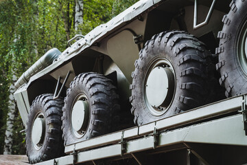 There is a long row of military vehicles that are currently positioned and resting on top of a...