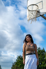 Young woman seen standing on basketball court