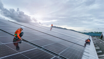 Engineers or technicians in safety gear meticulously inspecting and maintaining large-scale solar...