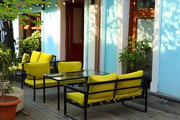 Bright soft sofas on the restaurant veranda