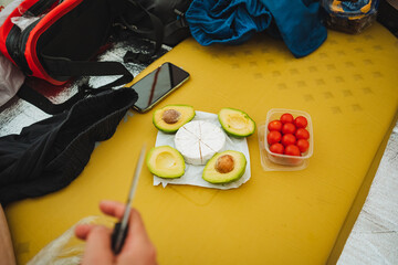 An individual is expertly cutting a variety of delicious food while seated comfortably on a cozy...