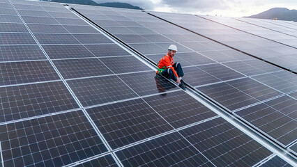 Engineers or technicians in safety gear meticulously inspecting and maintaining large-scale solar...