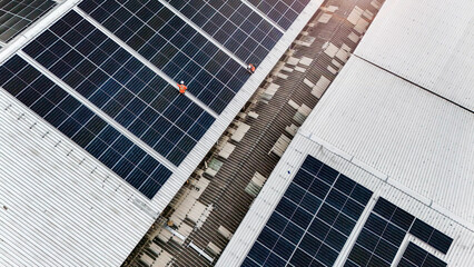 technician installs a large photovoltaic system on an industrial rooftop. ESG investment, and the...