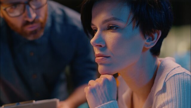 Business people man woman working computer teamwork discussion online project at night overtime office Caucasian businessman businesswoman professional workers colleagues talking financial technology