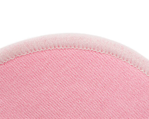    An extreme close-up of a pink reusable cotton facial cleansing pad, revealing its soft, detailed...