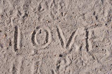 Love written in the sand expressing romance and affection