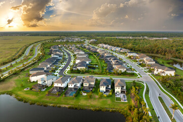 Obraz na płótnie Canvas American gated community houses in rural US suburbs. View from above of large residential homes in small town in southwest Florida