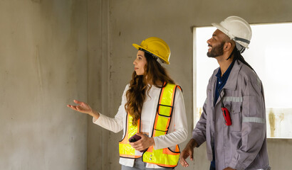 Professional architect and foreman two person wear head hat talk meeting safety work team 
check...