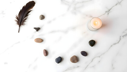 Arrangement of smooth stones, a feather, and a lit candle on a marble surface, creating a serene and calming atmosphere for relaxation and mindfulness practices