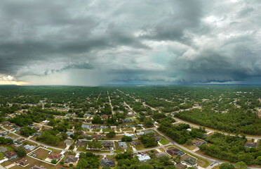 Landscape of dark ominous clouds forming on stormy sky during heavy thunderstorm over rural town...