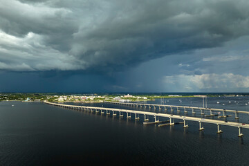 Stormy clouds forming from evaporating humidity of ocean water before thunderstorm over traffic...