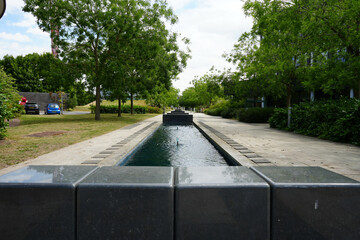Nottingham, Nottinghamshire, England - June 20 2025: Landscaped outdoor area with a water feature...
