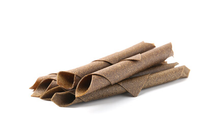 Delicious fruit leather rolls on white background