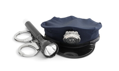 Police cap, flashlight and handcuffs on white background
