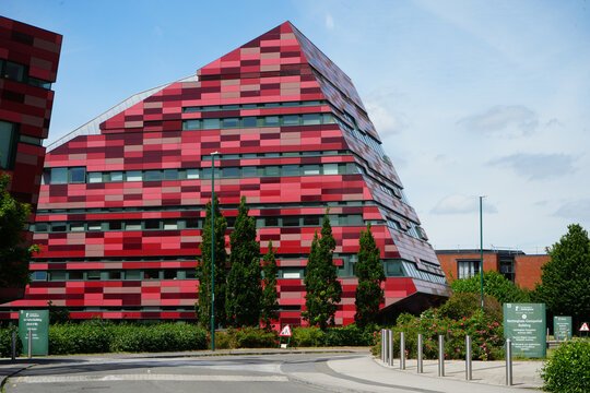 Nottingham, England - June 20 2025: Unique modern building showcasing a striking red and pink geometric pattern and angular design at University of Nottingham's Jubilee Campus.