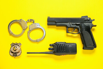 Different police equipment on yellow background, flat lay