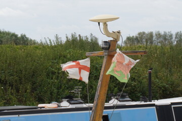 Nottinghamshire, England - June 20 2025: Pole with Saint George's Cross and Welsh Dragon flags, GPS...
