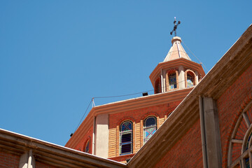 Historic Brick Building with Tower and Stained Glass
