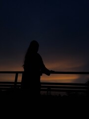 Fototapeta premium silhouette of a woman and a women on a beach