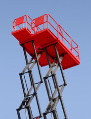 Group of red scissor lifts