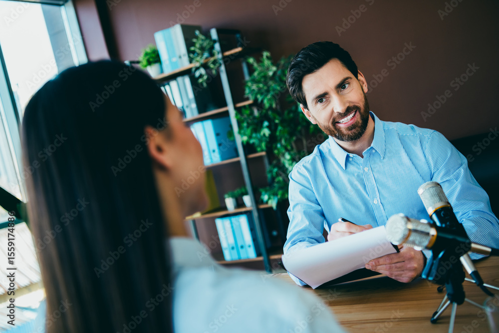 Poster business setting with a recruiter interviewing a job candidate in an office environment captured ind