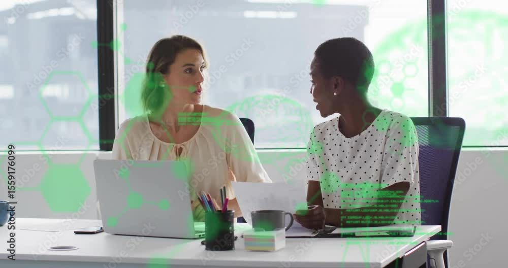 Poster hexagonal scrolling code overlay appearing, two women reviewing data at desk by pointing and typing