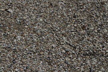 rocks and stones and pebbles texture. smooth pebbles background. variety of smooth, natural rocks with different shapes and textures. Processed collage of sea shore pebbles texture. 