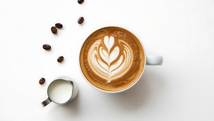 Aerial view of latte art coffee in a white cup with milk pitcher and scattered coffee beans on white